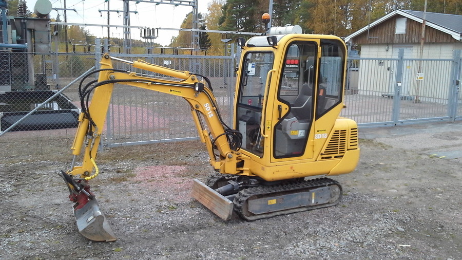 Minigrävare med redskap 