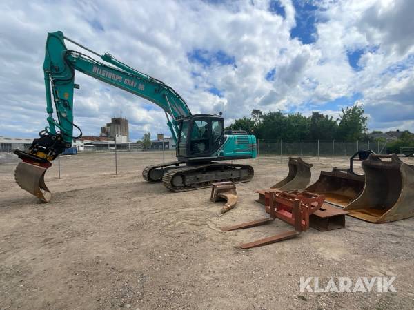 Bandgrävmaskin Kobelco SK210LC-10E med grävsystem och många redskap