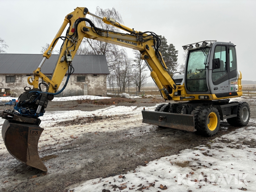 Grävmaskin New Holland MH 2.6 med SMP tiltrotator och planerskopa